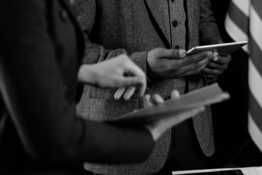 two people in formal clothing using tablets