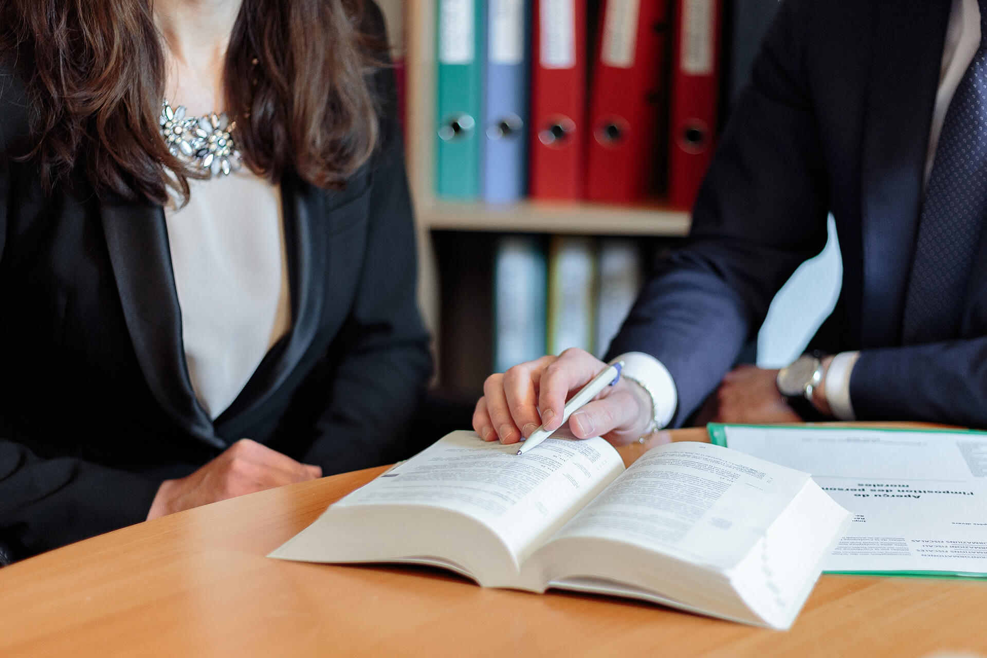 a person using a pen to point at something in a book