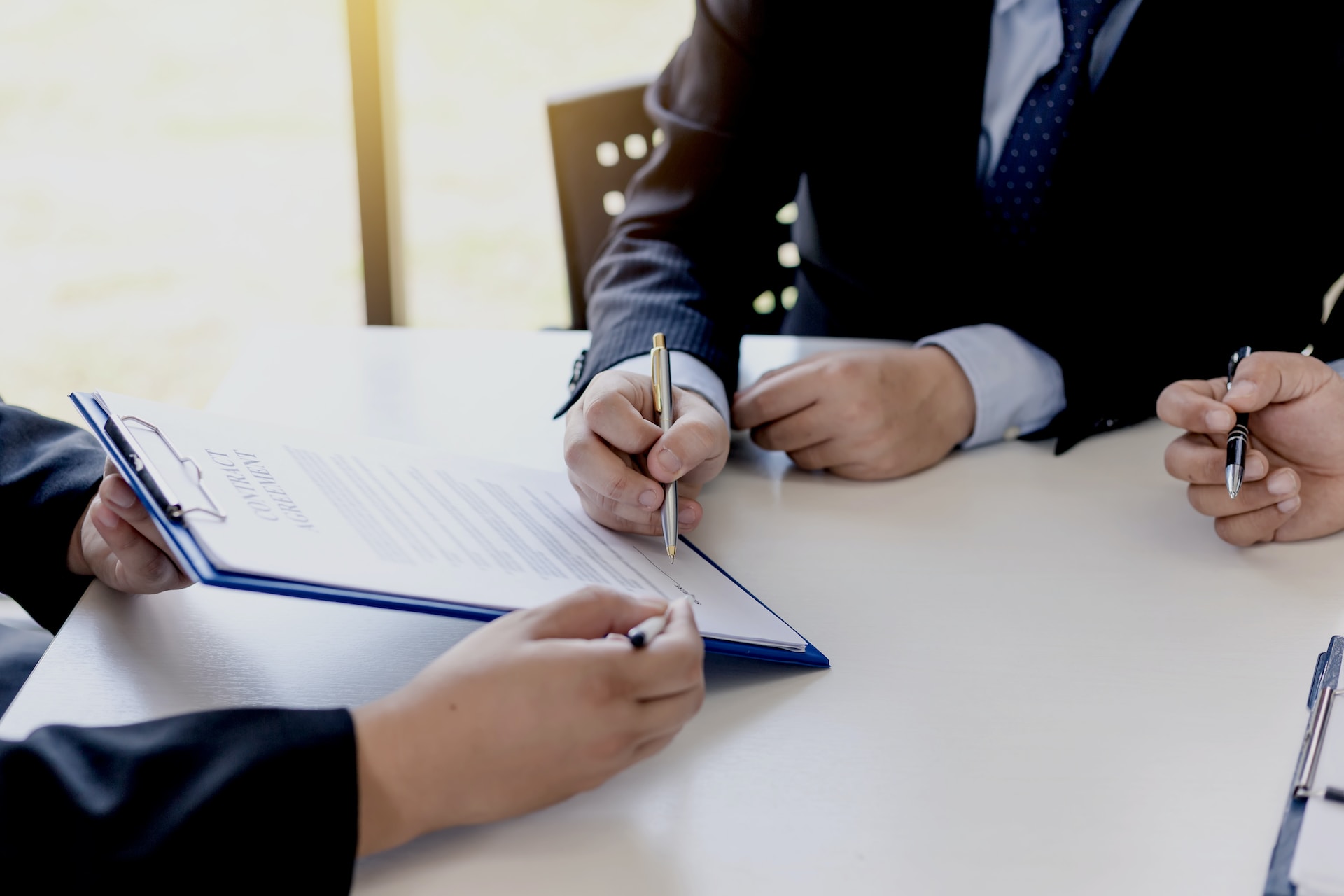 people signing a document
