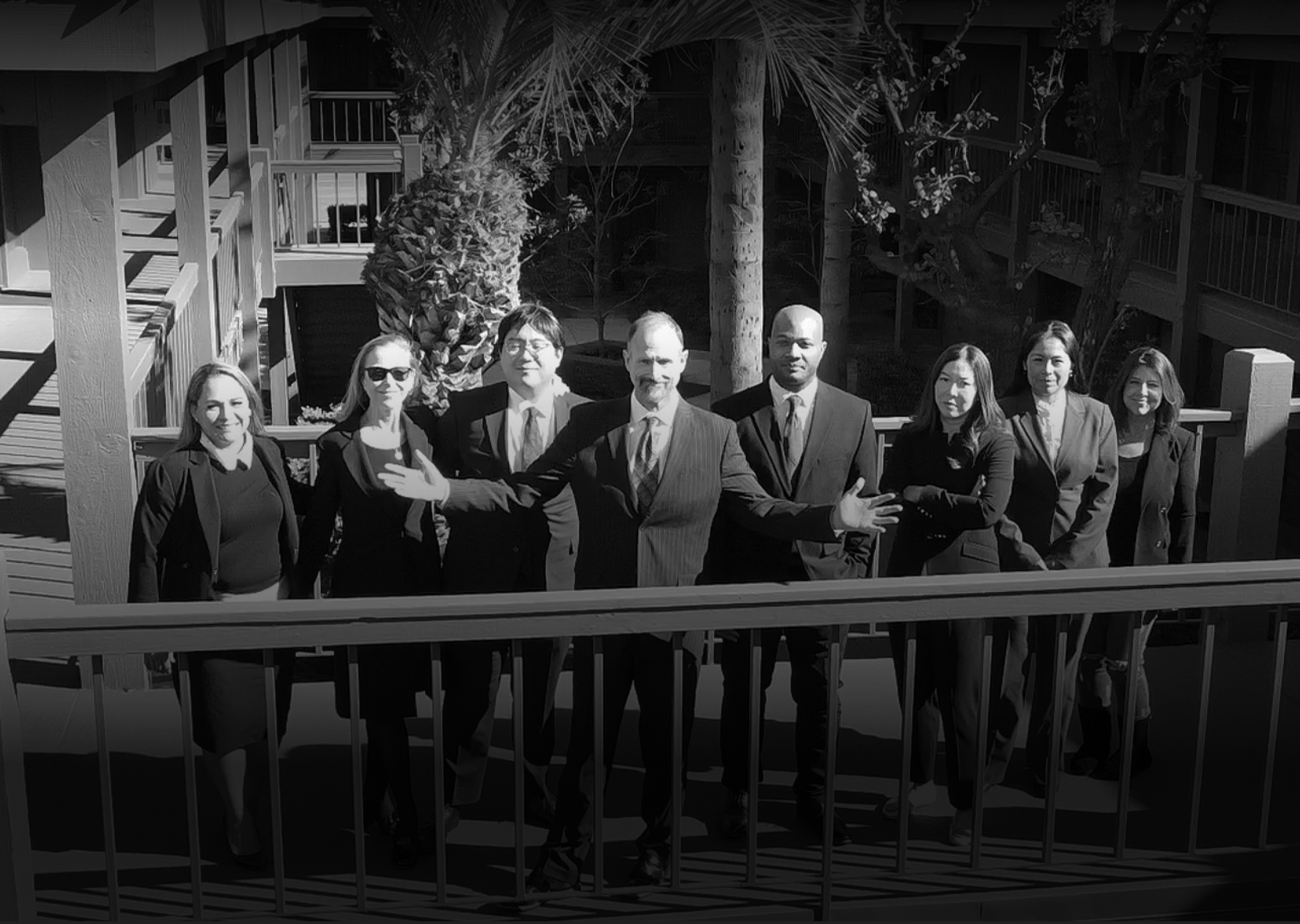 Pinkham & Associates team of lawyers standing on a balcony